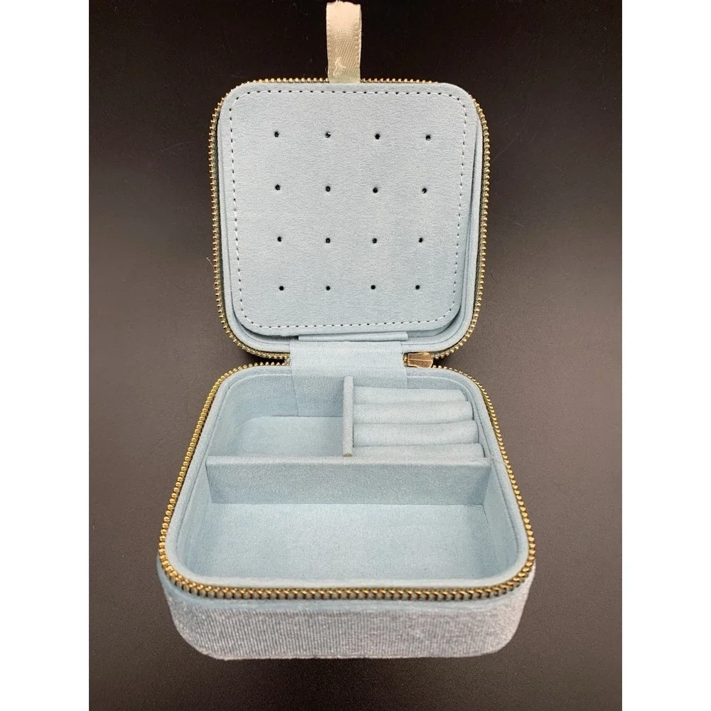 Small blue velvet jewelry box with a zipper